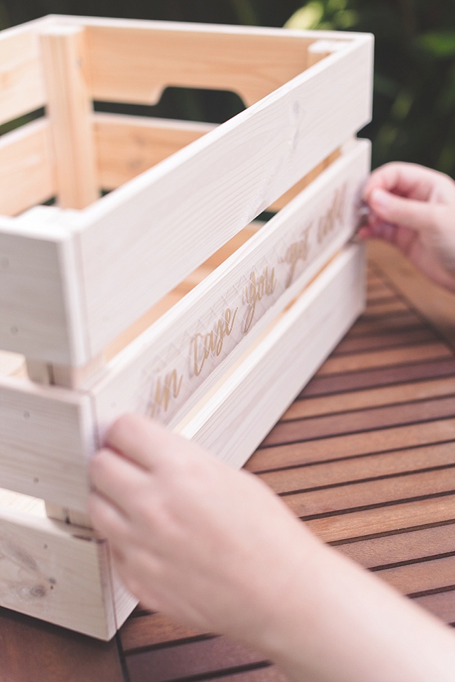 Applying shimmer vinyl to wood crate